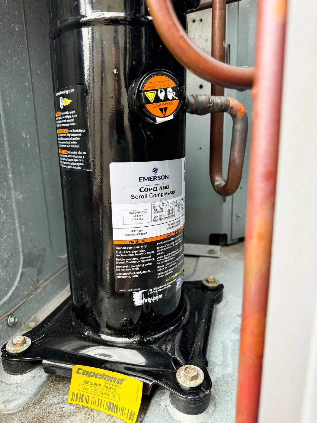 Emerson Copeland Scroll compressor mounted inside outdoor unit with copper lines