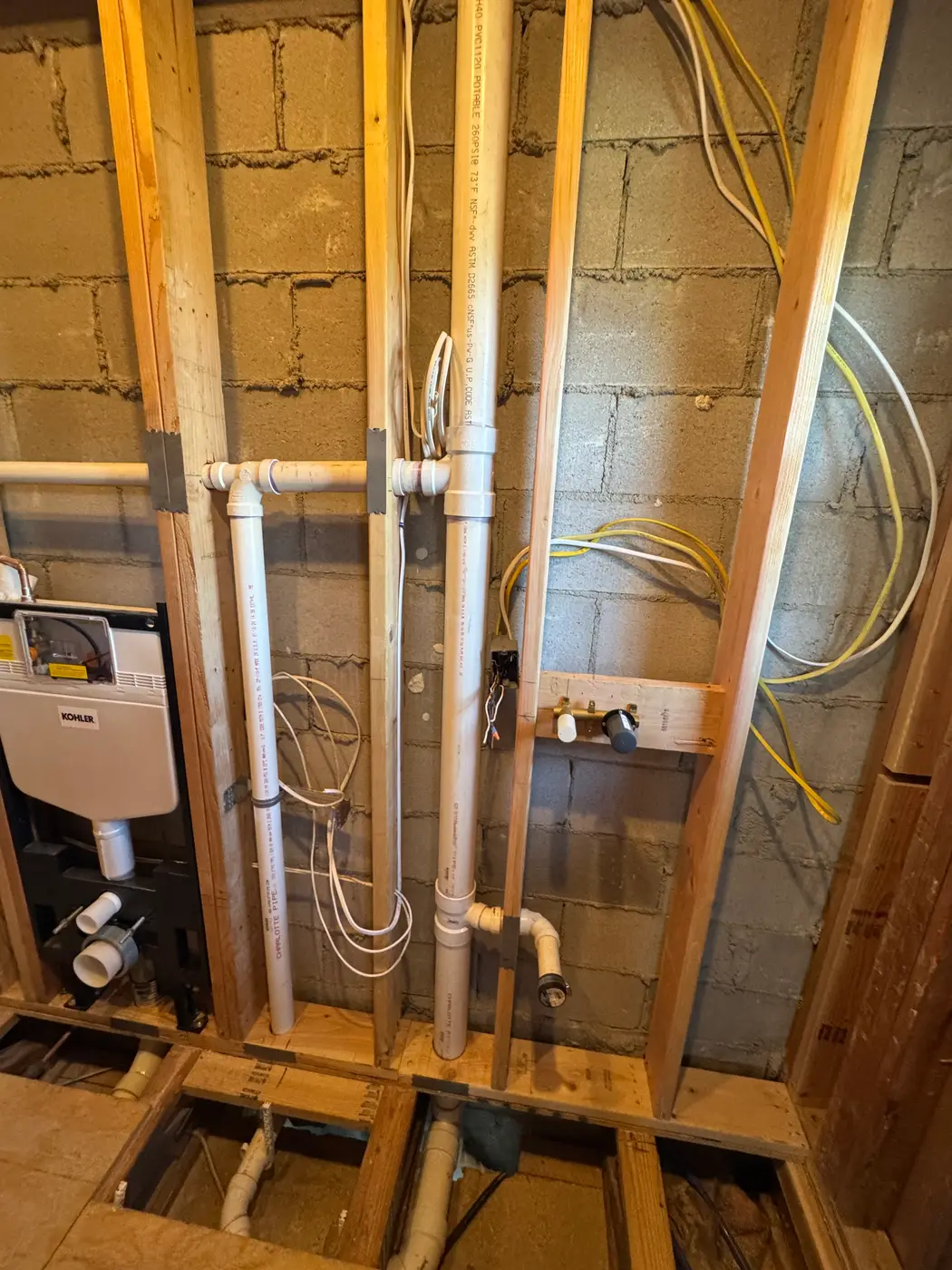 In-wall toilet carrier with PVC and copper lines in stud bay